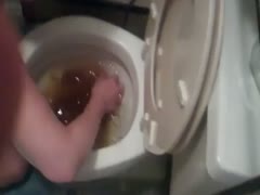 Matured slut uses her hands to get the shit in the toilet bowl